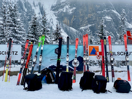 a group of skis and backpacks sitting in the snow